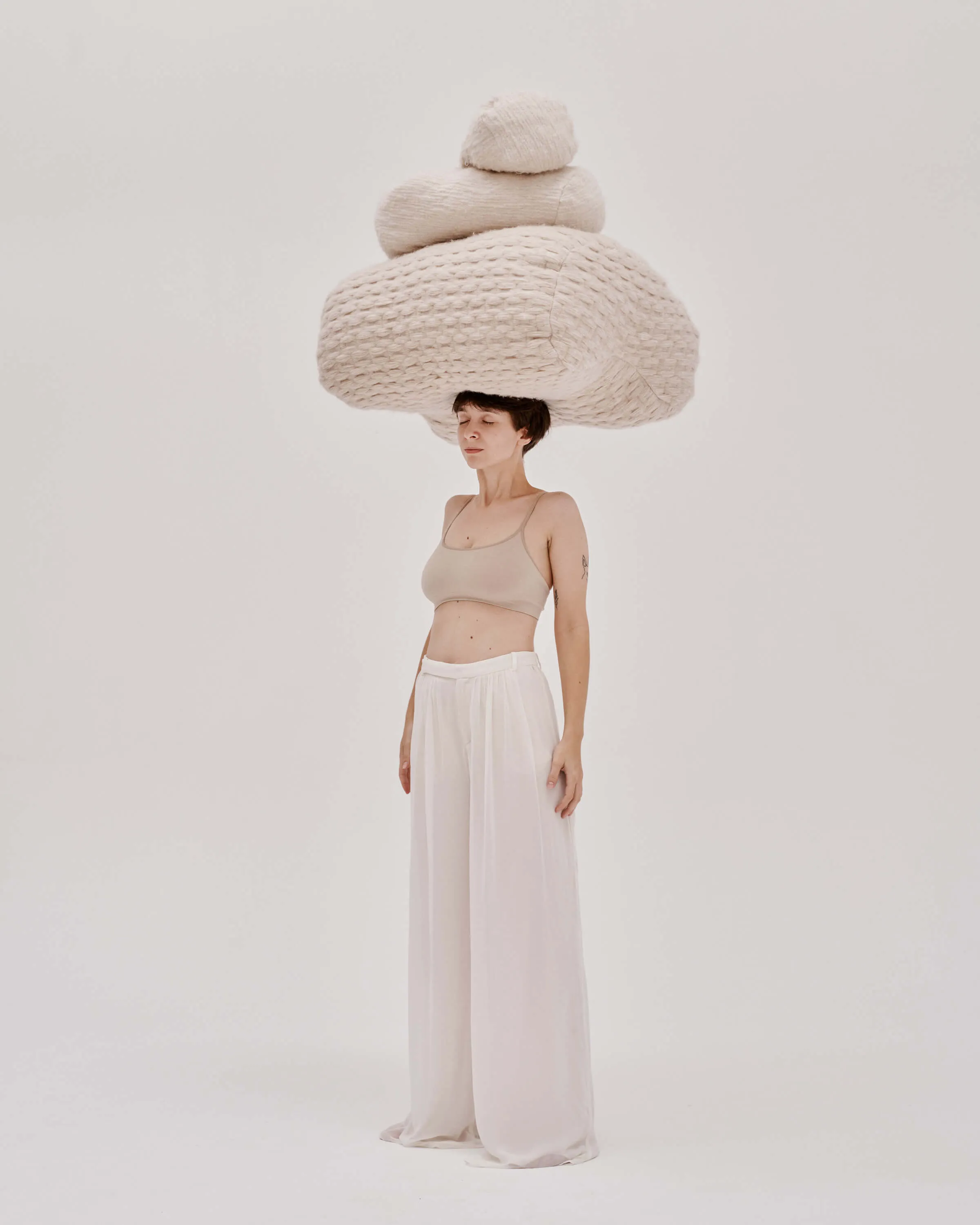 woman standing with a pillows made from Dominika's fabric on her head