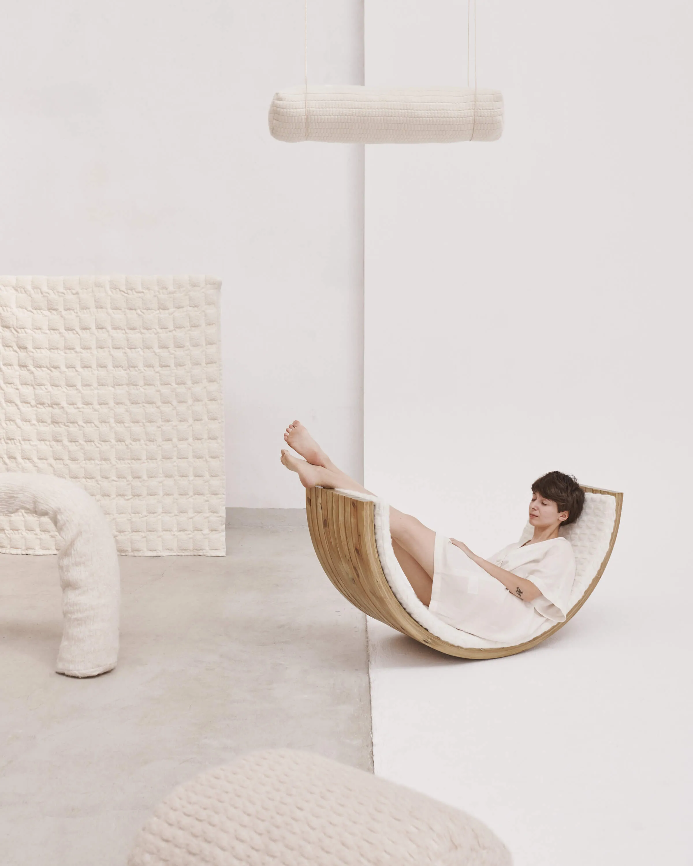 woman sitting in the wooden object made with Dominika's fabric